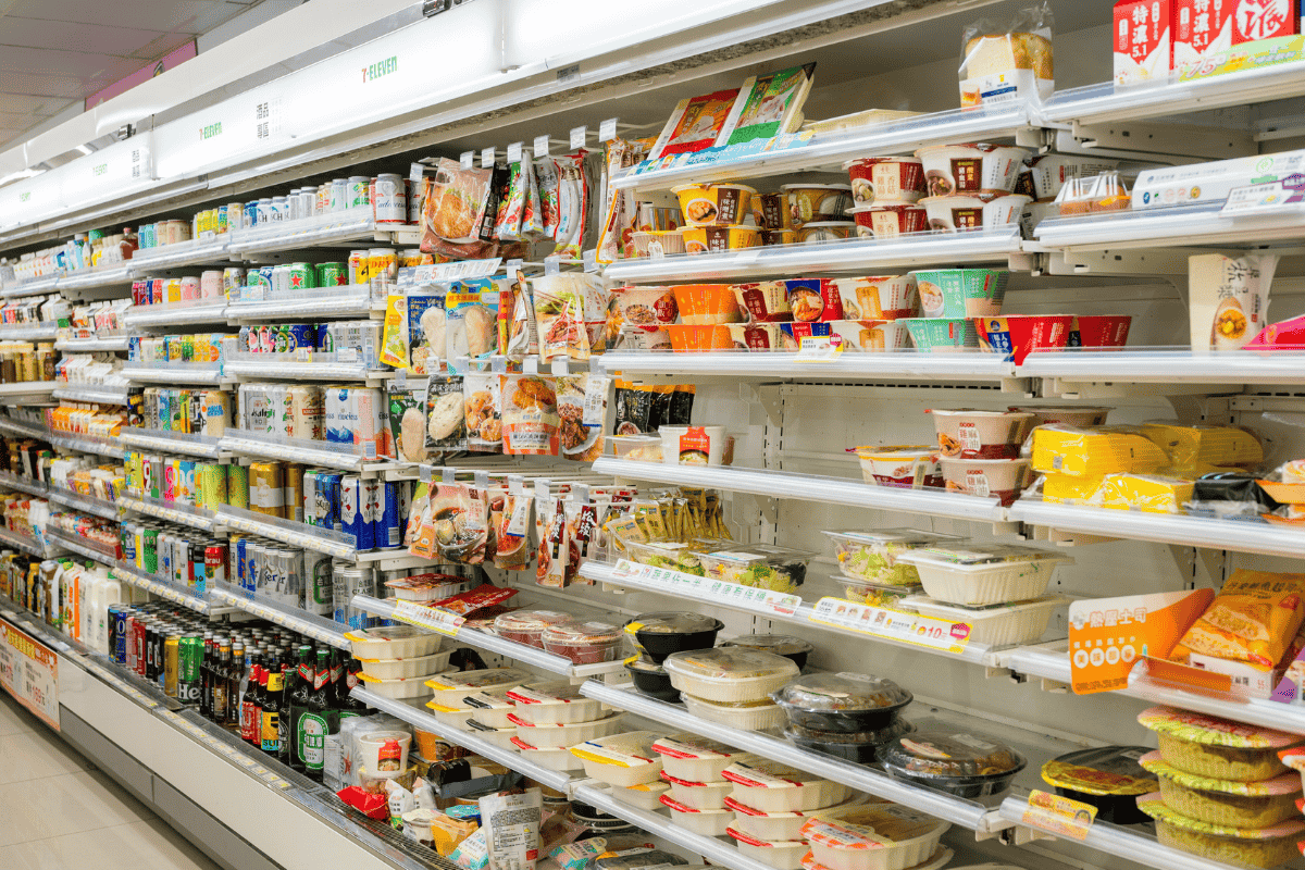 A quiet Japanese convenience store at night, showing its clean and well-organized interior