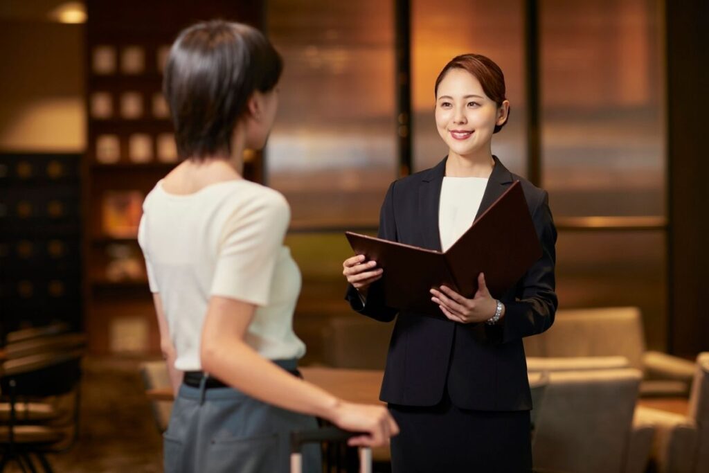 Japanese customer service staff bowing politely to a customer